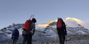 Annapurna Circuit Tilicho Lake Trek 2 Annapurna Circuit Tilicho Lake Trek | Hikers approaching snowy mountain pass.